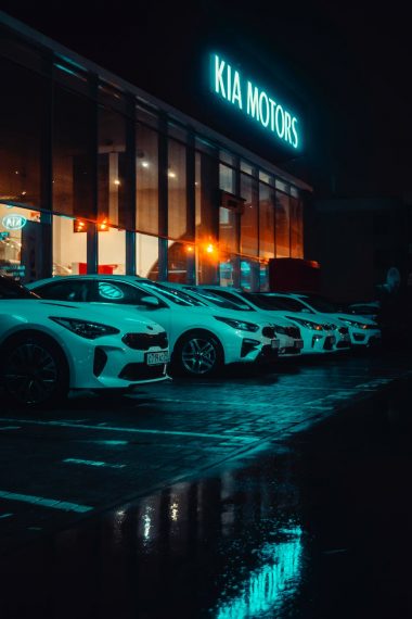 white vehicles parked outside kia motors building