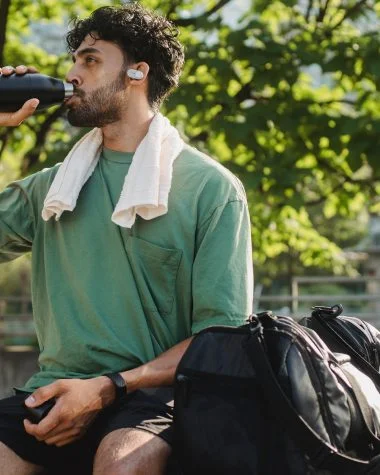 man drinking from a bottle after an exercise
