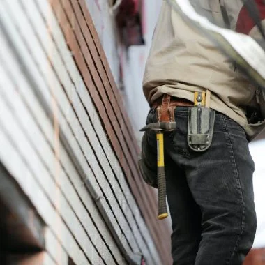 man wearing black denim pants with carrying hammer on holster