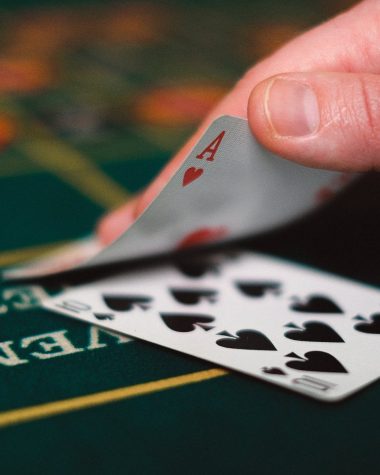 close up of person with cards in casino